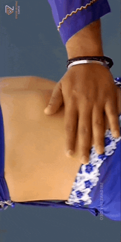 a close up of a person 's hand on a woman 's belly .