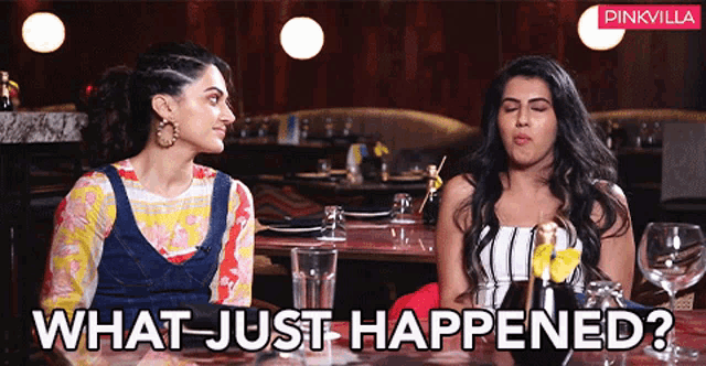 two women are sitting at a table with the words " what just happened " on the bottom