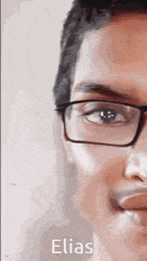 a close up of a man wearing glasses with the name elias written on the bottom