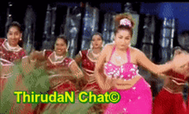 a group of women are dancing in front of a sign that says thirudan chat