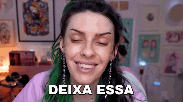 a woman with green hair is smiling and the words deixa essa are on her face