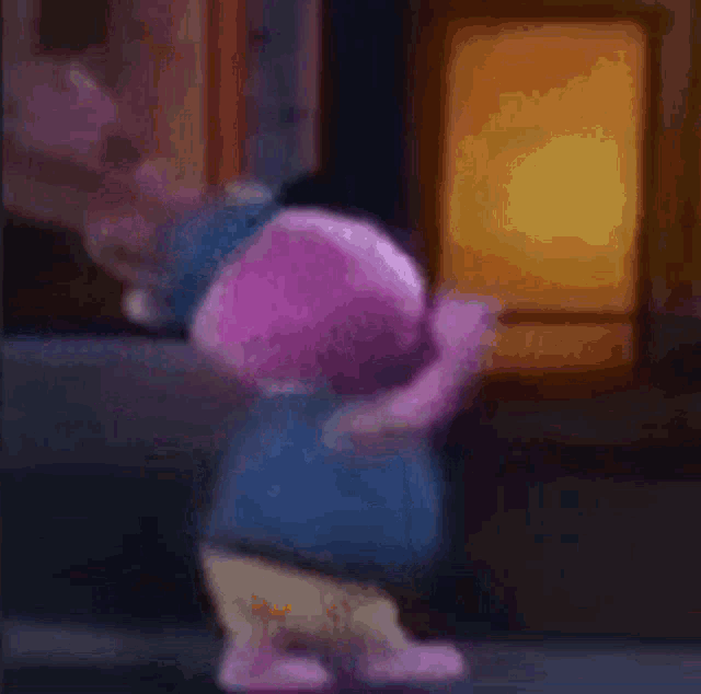 a stuffed animal is standing in front of a window in a room .