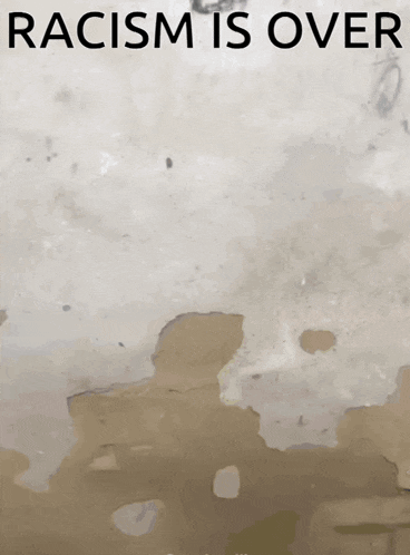 a poster that says racism is over with a dirty wall in the background