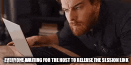 a man is laying on a table looking at a laptop .