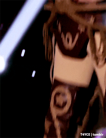 a close up of a person wearing a louis vuitton scarf .