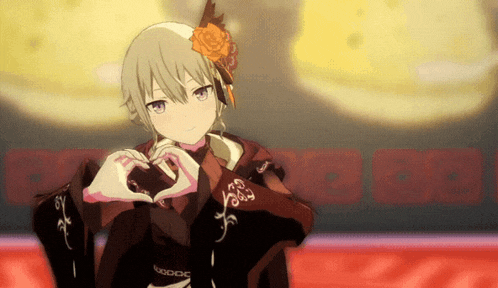 a girl with a rose in her hair is making a heart with her hands .