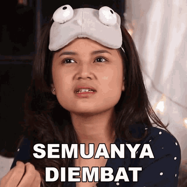 a woman wearing a sleep mask with big eyes says " semuanya diembat "