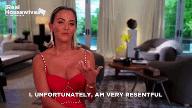 a woman in a red dress says " unfortunately am very resentful "