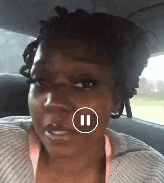 a woman sitting in the back seat of a car with the number 11 on her face