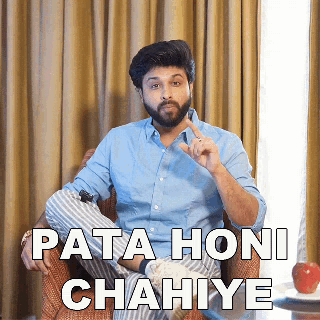 a man with a beard is sitting in a chair with the words pata honi chahiye