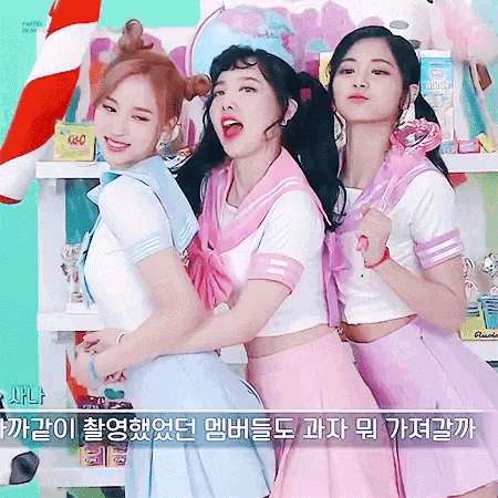 a group of three girls are posing for a picture together in a room .