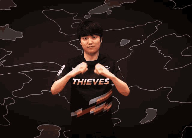 a man wearing a shirt that says thieves on it