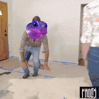 a man with a frog on his head is standing in a room with the word frogs on the bottom
