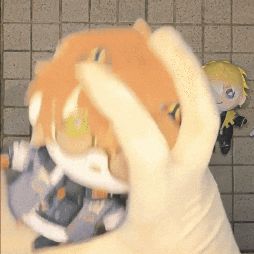 a person holding a stuffed animal with a yellow haired boy behind them