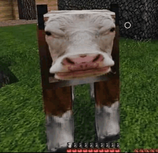 a cow in a minecraft video game is standing in the grass .