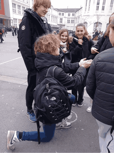 a person wearing a black north face backpack