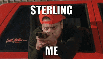 a man in a red hat is pointing a gun at the camera with the caption sterling me below him