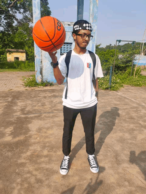 a man is holding a basketball that says ' coors ' on it