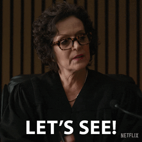 a woman in a judge 's gown says let 's see