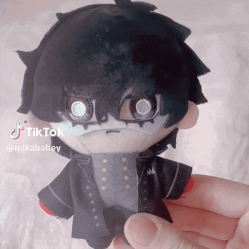 a person is holding a stuffed toy with a tiktok watermark