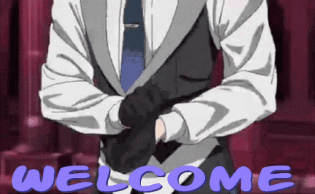 a man in a suit and tie is standing in front of a welcome sign