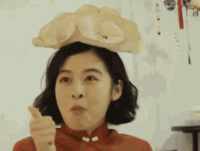 a woman with a flower on her head is making a funny face
