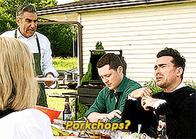 a group of people are sitting at a table with the words pork chops written on the bottom