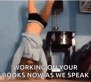 a woman is doing a handstand in a room with the words `` working on your books now as we speak '' behind her .
