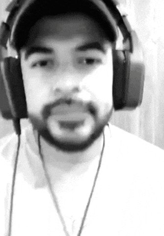 a black and white photo of a man wearing headphones