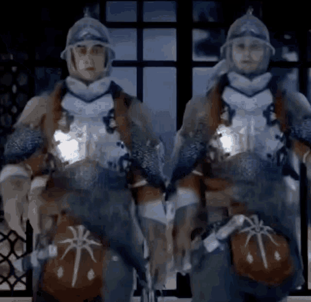 two soldiers in armor are standing next to each other