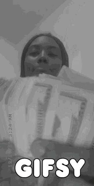 a black and white photo of a person with the word gifsy on the bottom right