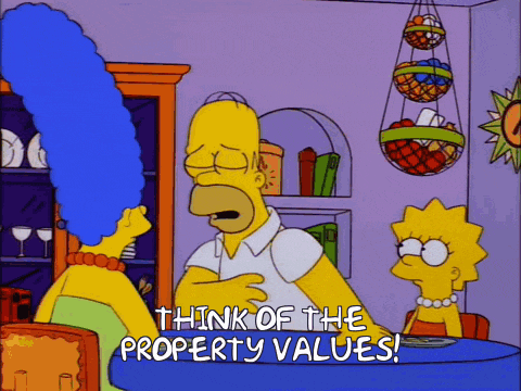 homer simpson is talking to marge simpson and lisa simpson and says think of the property values
