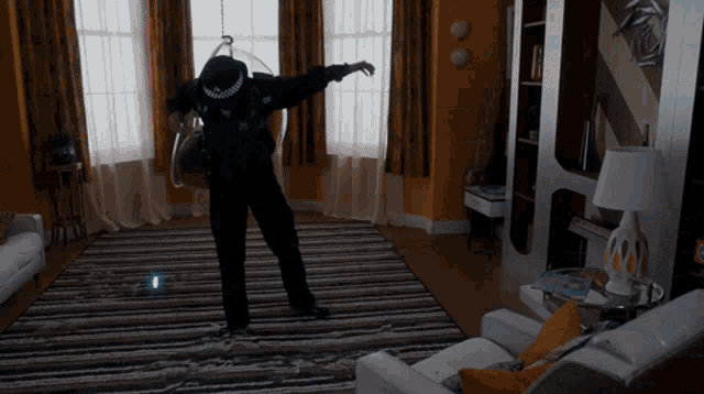 a man in a police uniform stands in a living room