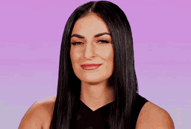 a woman with long black hair is smiling with her eyes closed against a purple background