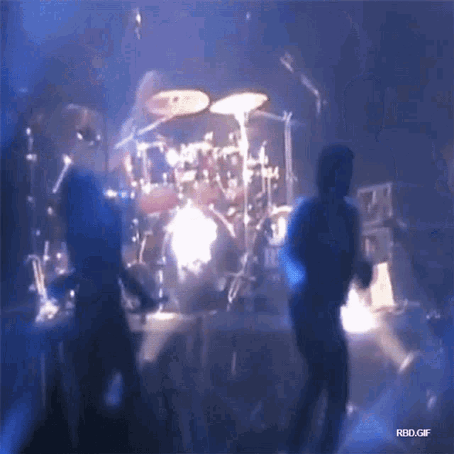 a group of people playing drums on a stage with the words rbd.gif on the bottom