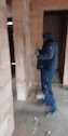 a man in a blue jacket is standing in a hallway .