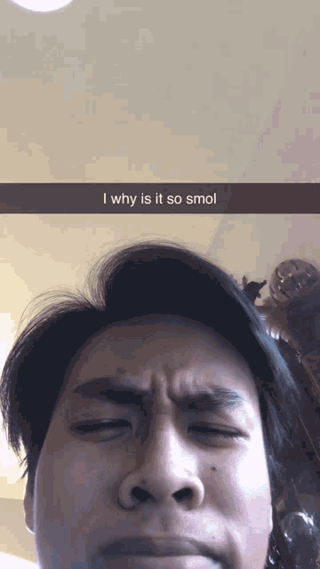 a man with his eyes closed has a snapchat caption that says i why is it so smol