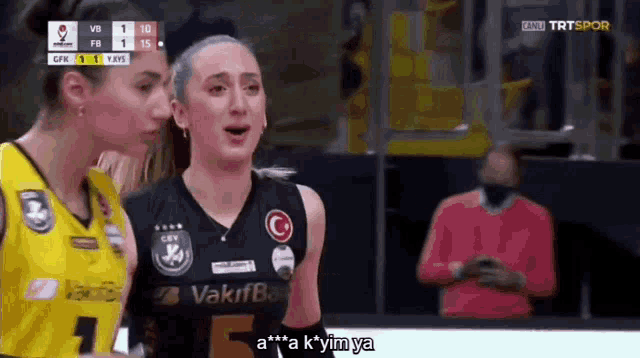 two women are standing next to each other on a basketball court and one of them is wearing a shirt that says vakıfbank