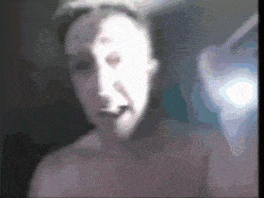 a blurred image of a woman with a white face