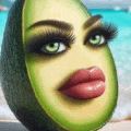 a slice of avocado with a woman 's face on it is on a beach .