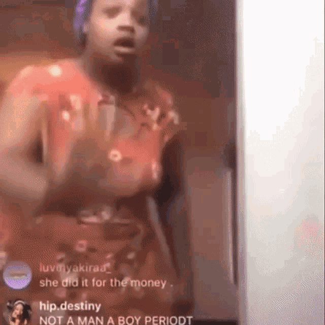 a woman in a red dress is standing in front of a computer screen and talking .