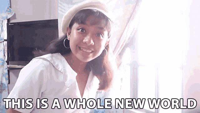a girl is smiling and says this is a whole new world .