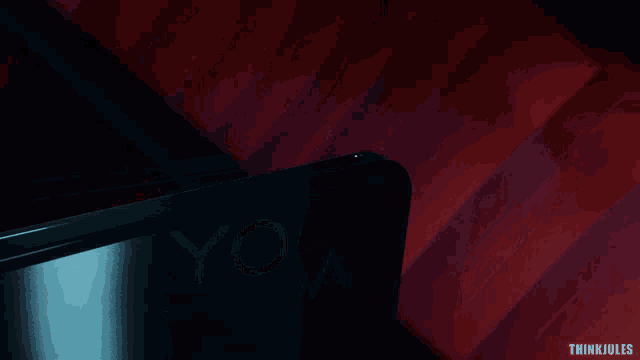 a yoga laptop is sitting on a red staircase