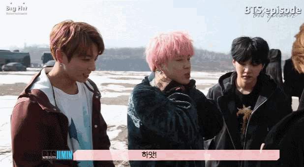 a group of young men standing next to each other with big hit written on the bottom right