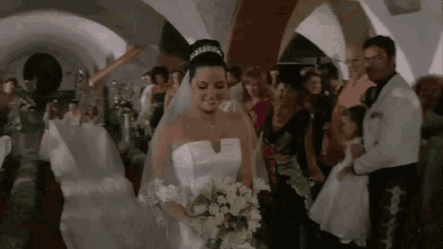 a bride and groom are walking down the aisle at a wedding