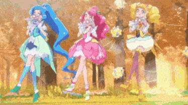 three anime girls are standing next to each other in a field .