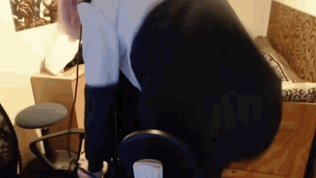 a person is sitting in a chair in front of a microphone .
