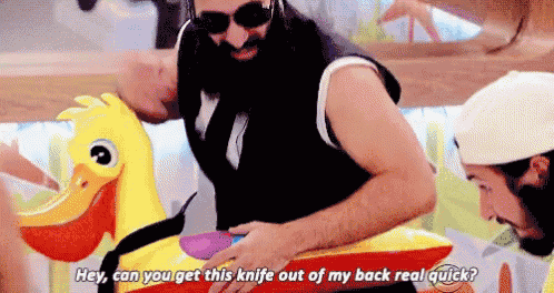 a man with a beard is riding an inflatable duck and saying hey can you get this knife out of my back real quick .