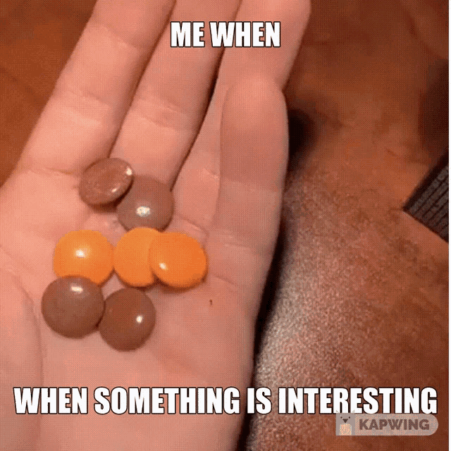 a hand holding a bunch of candy with a caption that says me when when something is interesting
