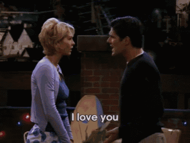 a woman says i love you to a man in a dark room